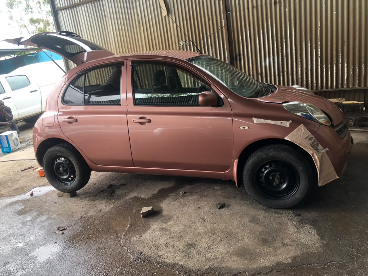 Freshly refinished vehicle panel after spray painting at DOP